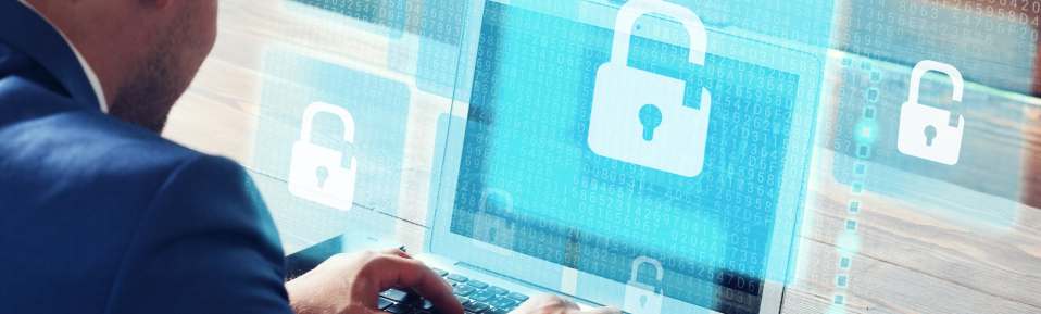 man using a computer with lock symbols representing security