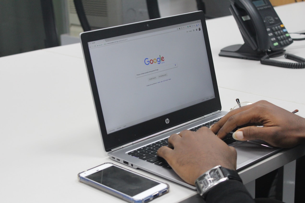 man searching on Google using a laptop