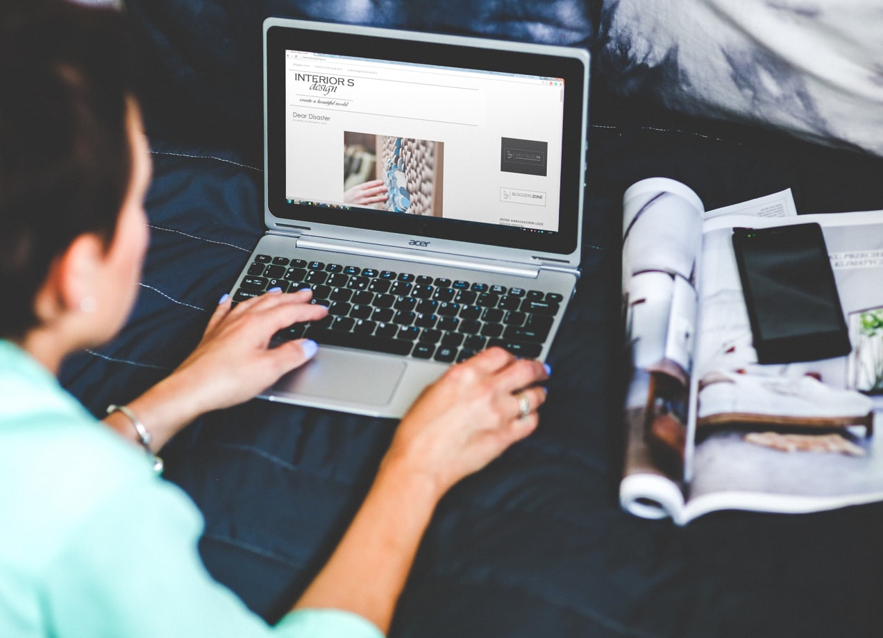 woman writing a blog post on a laptop