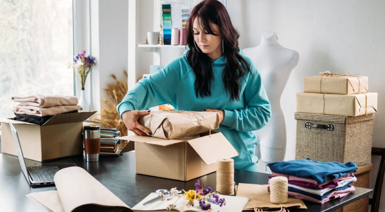 woman packing a box for shipping