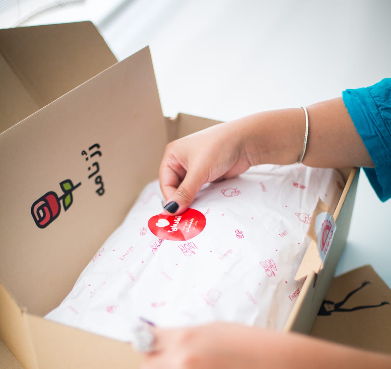 packing items for shipping, including branded materials