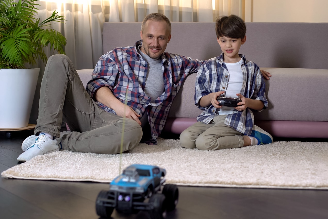 father and son racing an RC car together