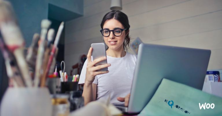 small business owner working on social media in her art studio