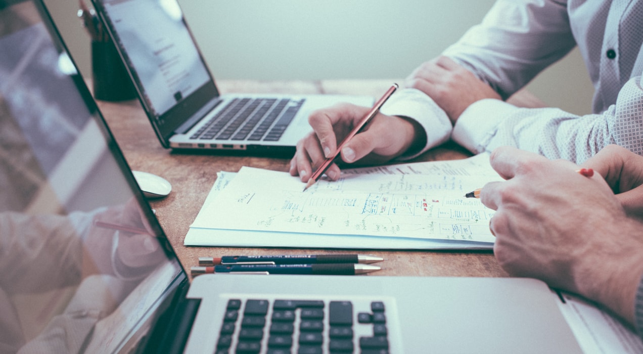 financial advisor working with an entrepreneur at a desk