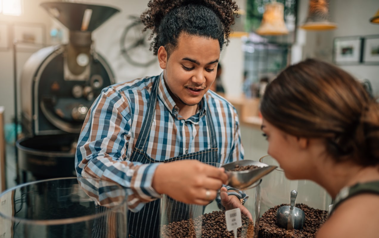 coffee shop owner serving coffee to a customer