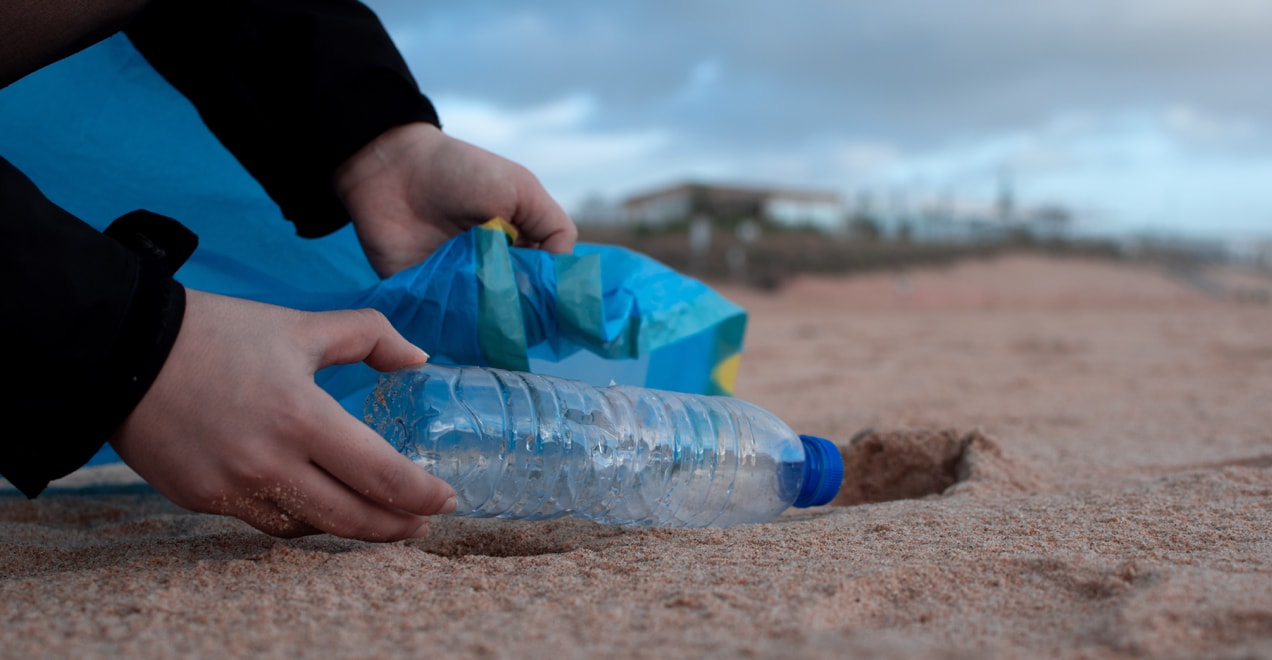 cleaning trash on a beach