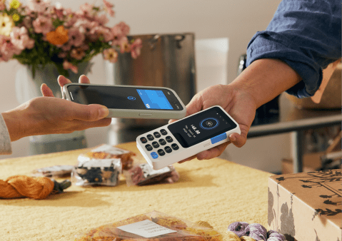Customer tapping their card to pay on a PayPal POS card reader