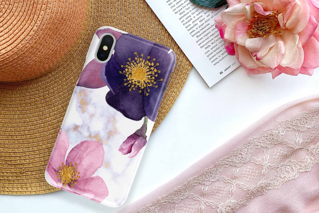 floral phone case next to a hat