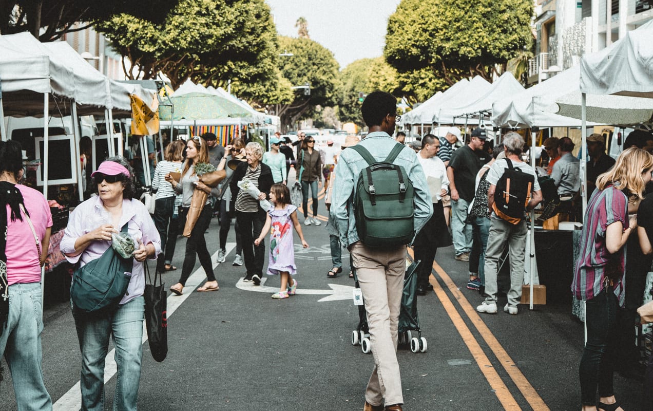 people shopping at an outdoor market