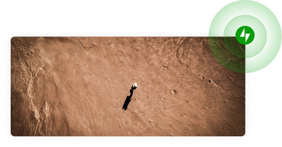 Top down view of a person in a spacesuit walking on Mars