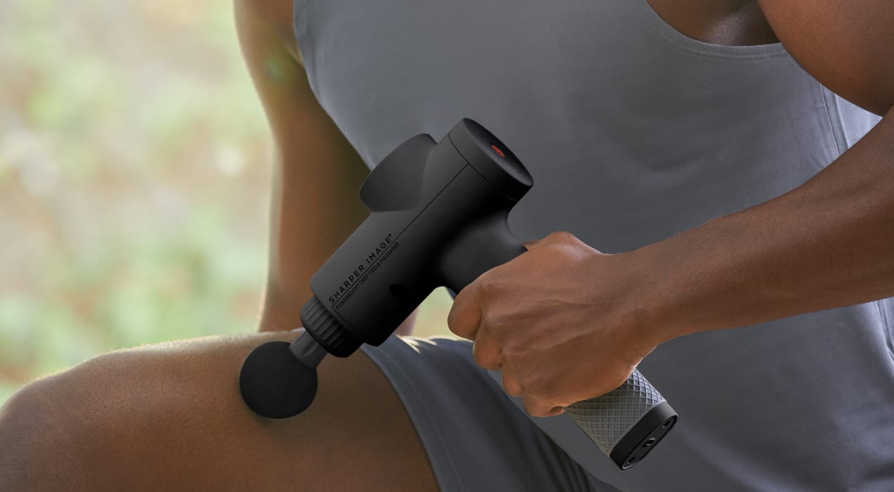 Sharper Image massage gun used on a leg