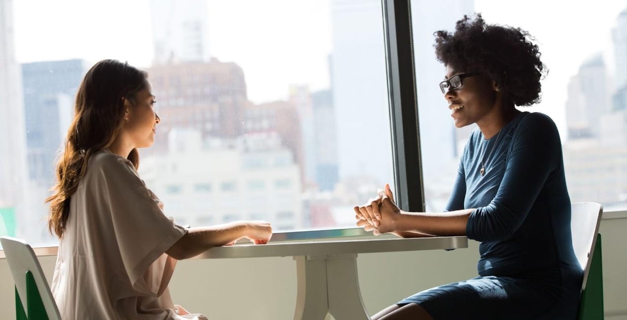 two women meeting at a table