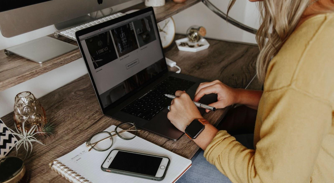 woman working on a laptop at her desk