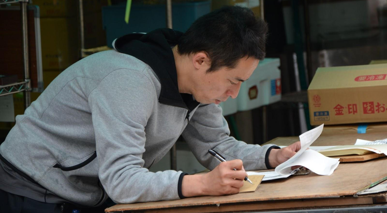 man reviewing inventory list in a warehouse