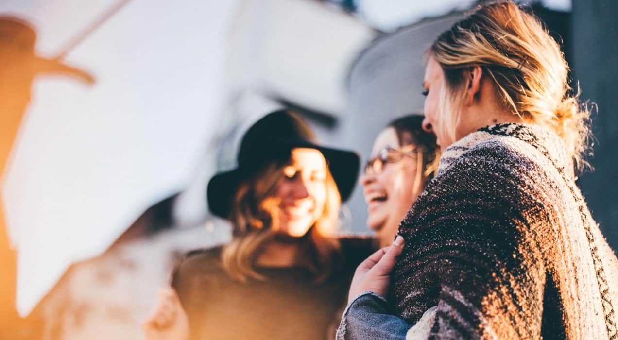 three women laughing together