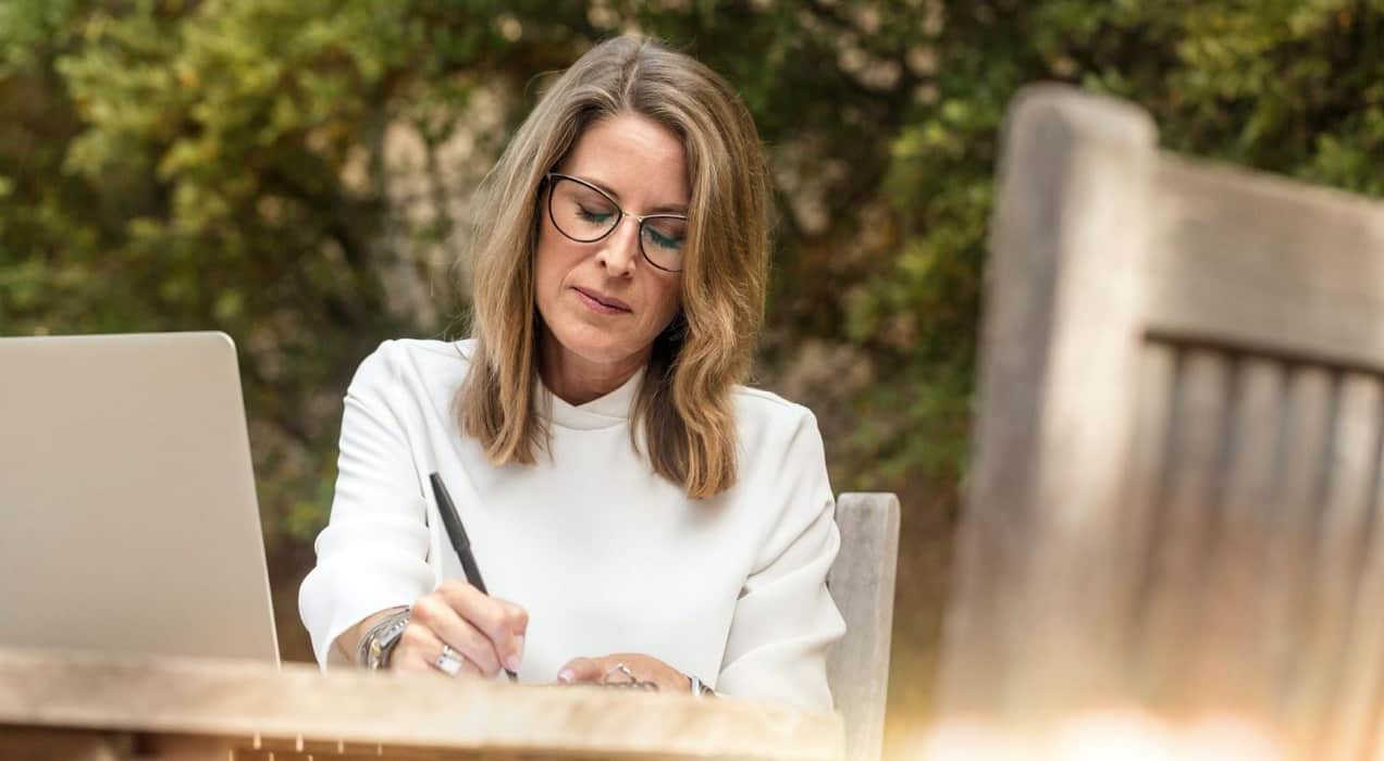 woman writing outside