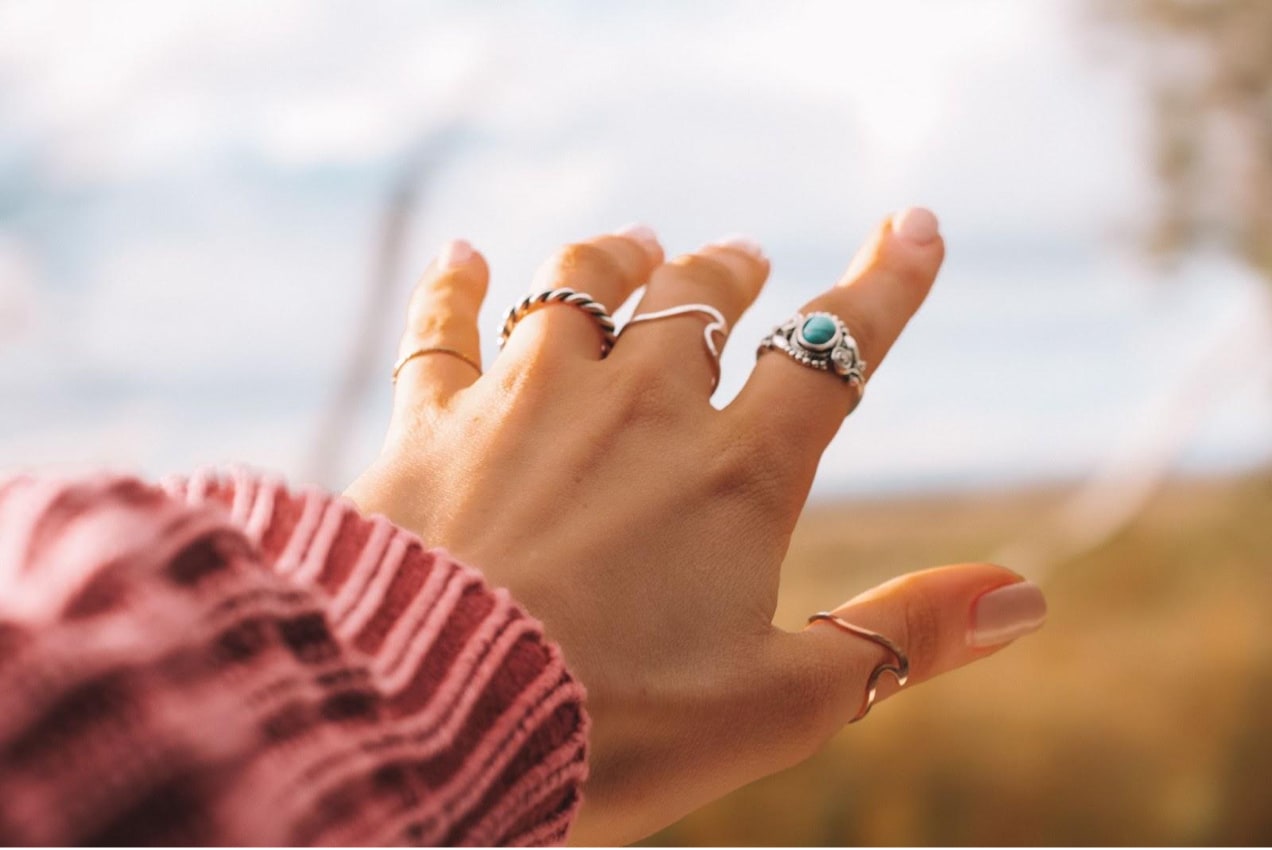 custom rings on someone's fingers