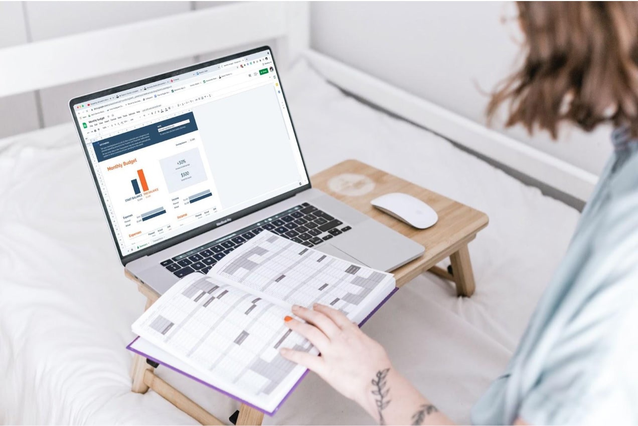 woman working on her laptop and a notebook