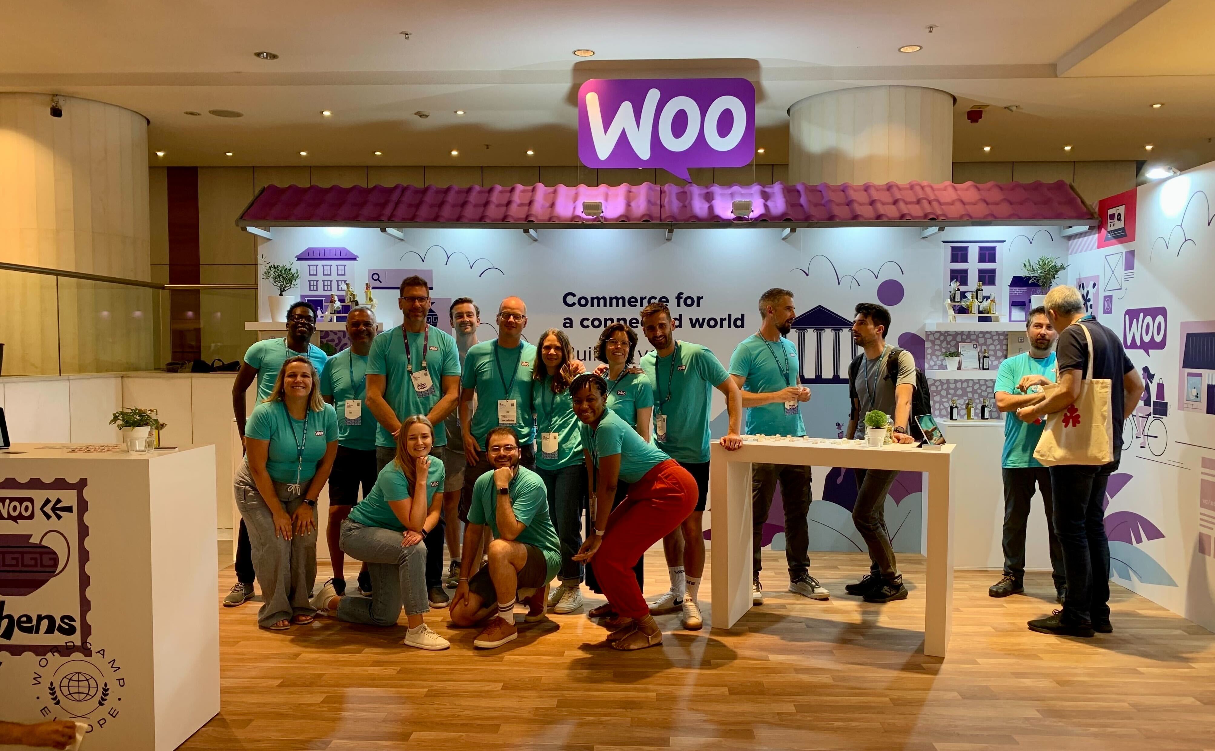 A group of Woo employees in the Woo booth at WordCamp Europe 2023.