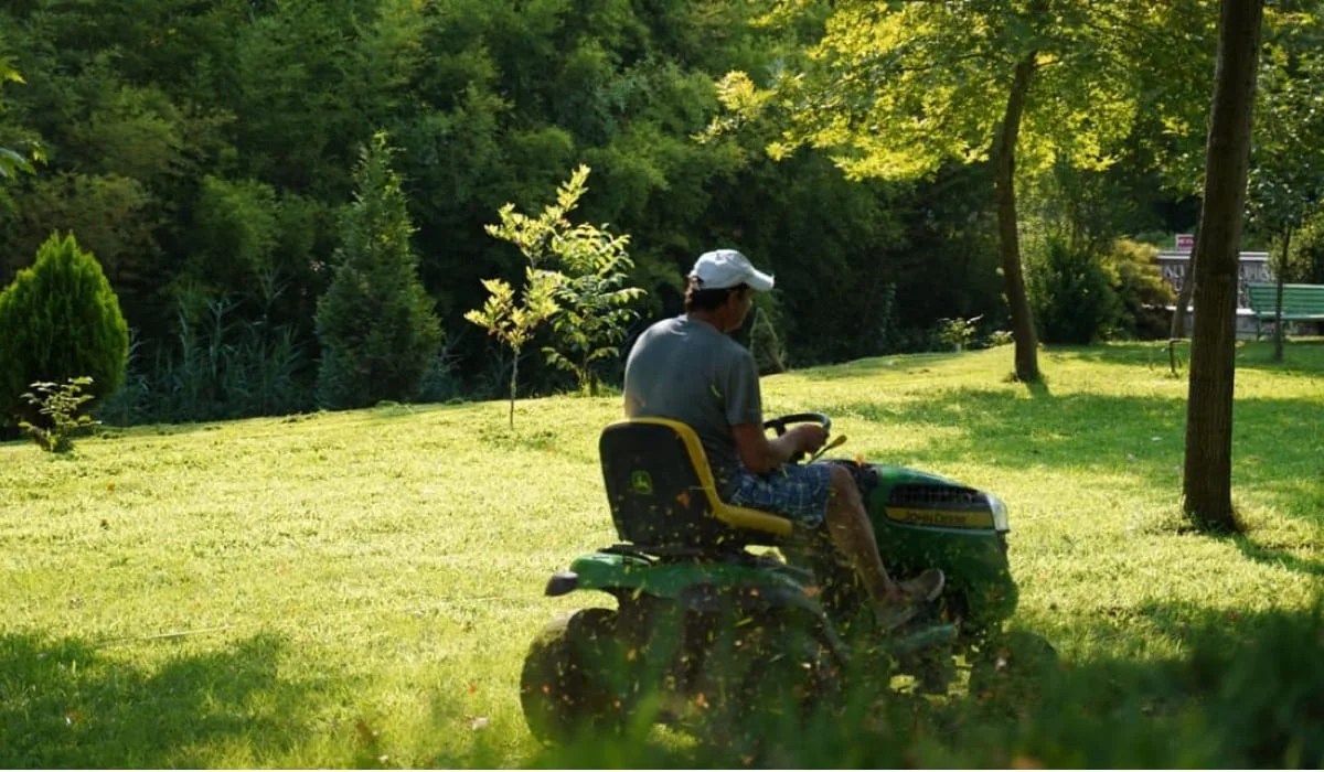 man mowing a lawn on a riding lawn mower