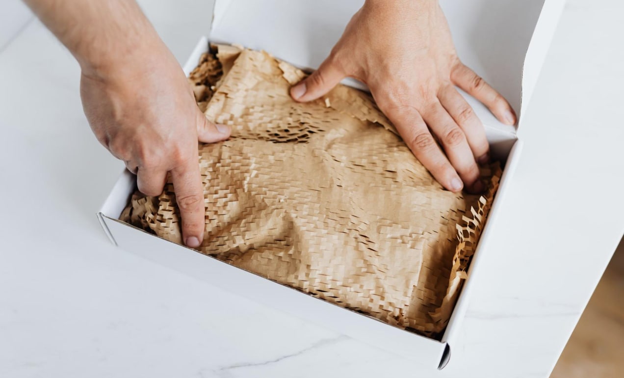 shop owner packing a box to ship