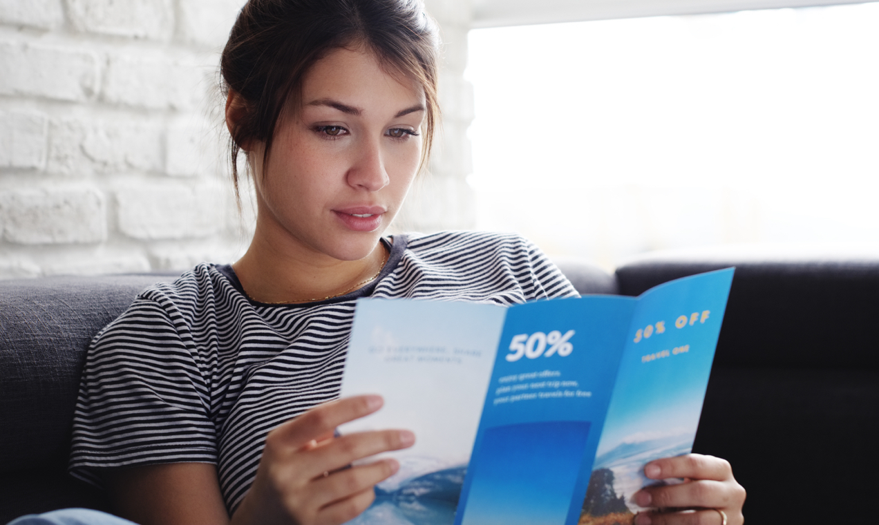 women reading a trifold brochure