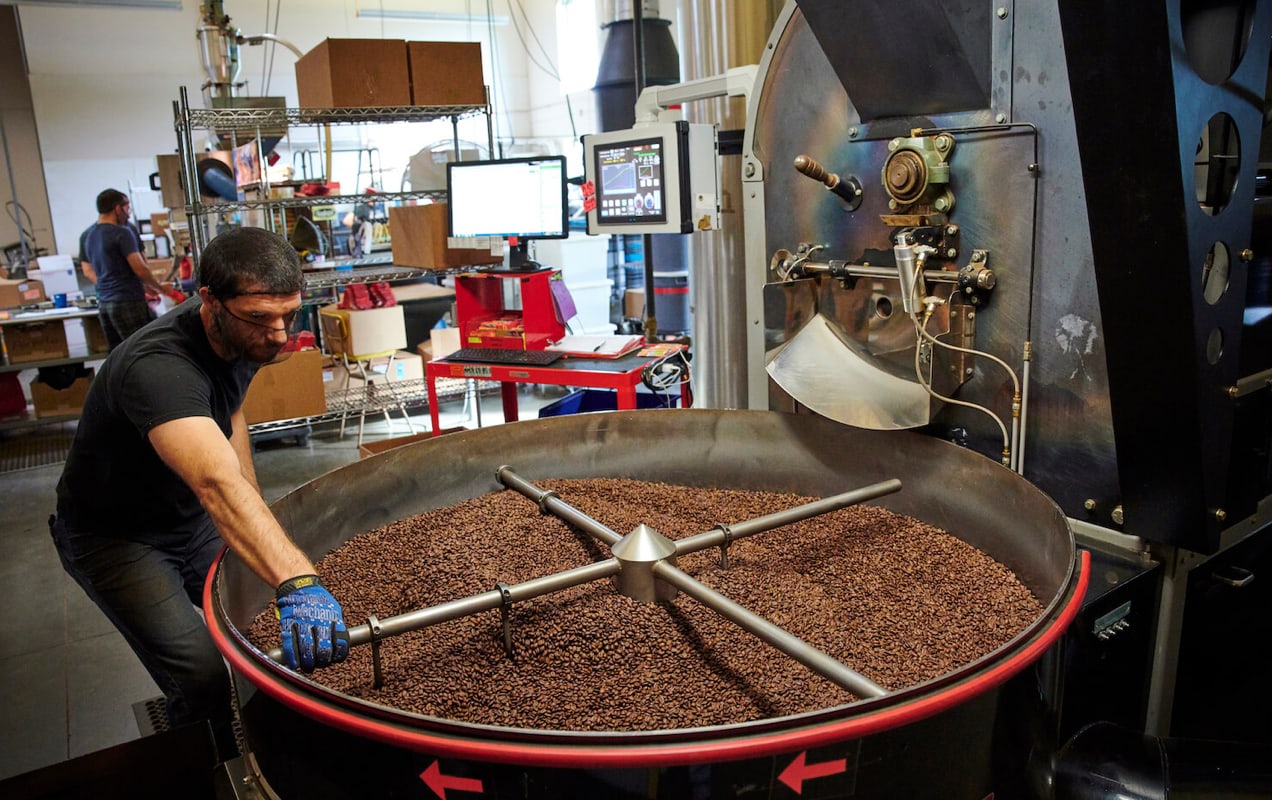 man roasting coffee beans