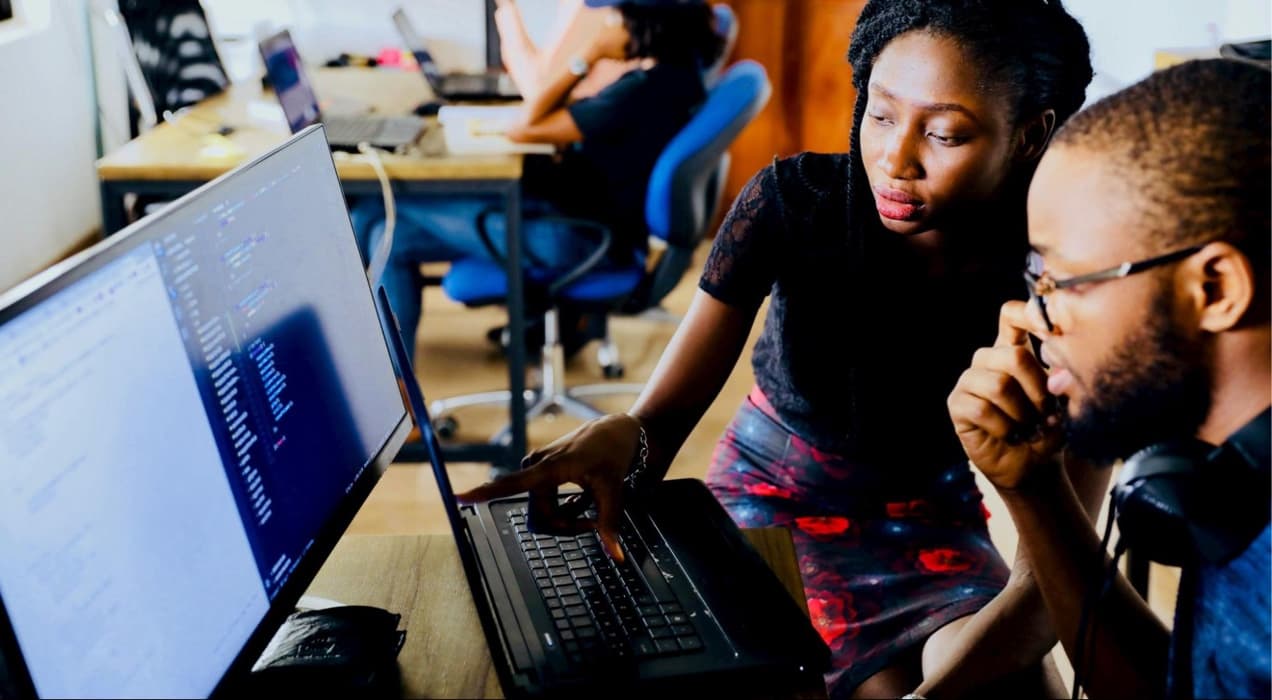 two developers working in front of a computer