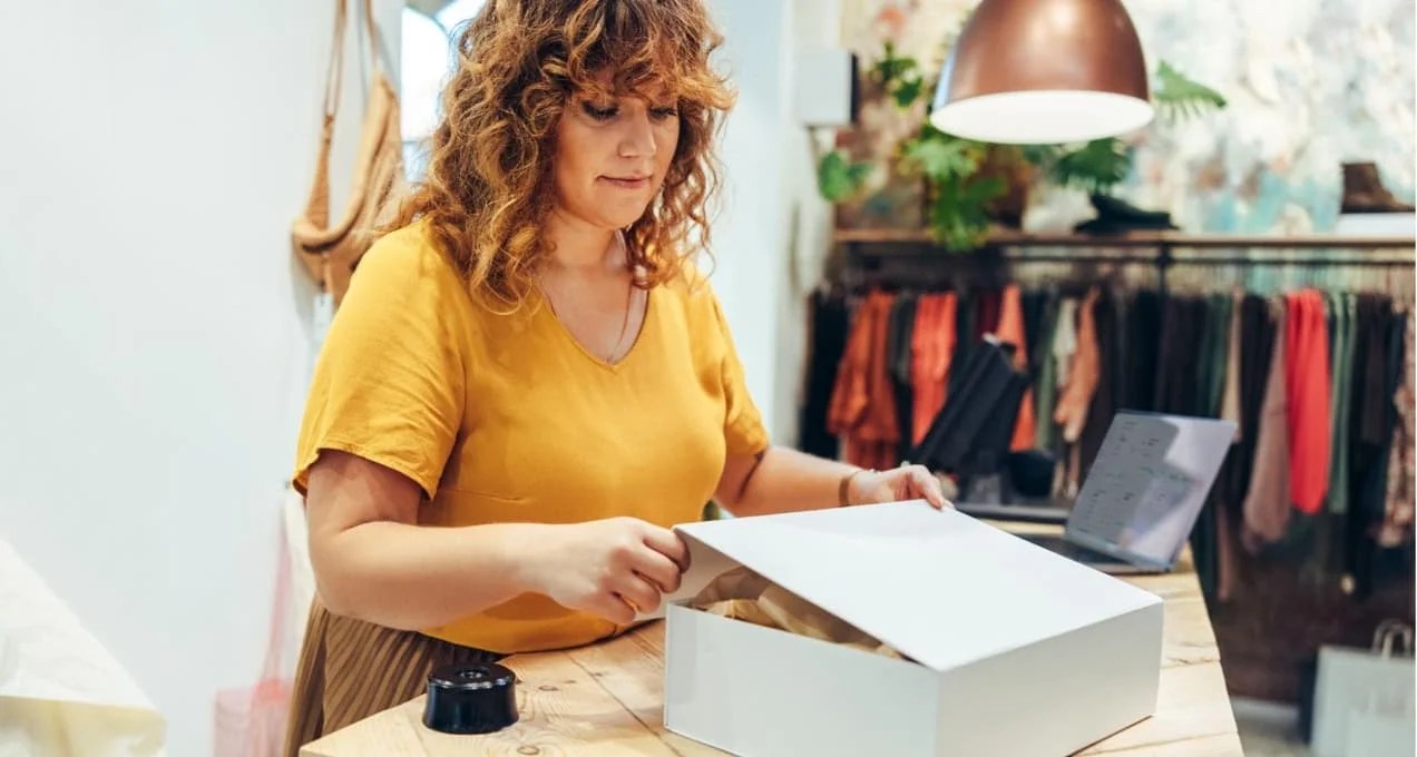 woman packing a box for shipping