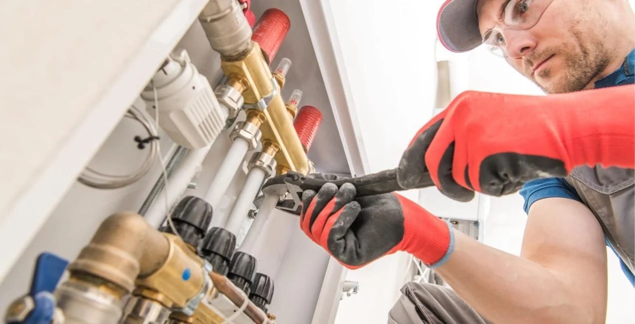 plumber working underneath a sink