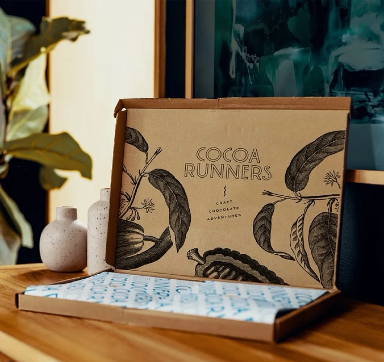 Box from cocoa runners, open to show a beautiful cacao bean design on the inside of the box