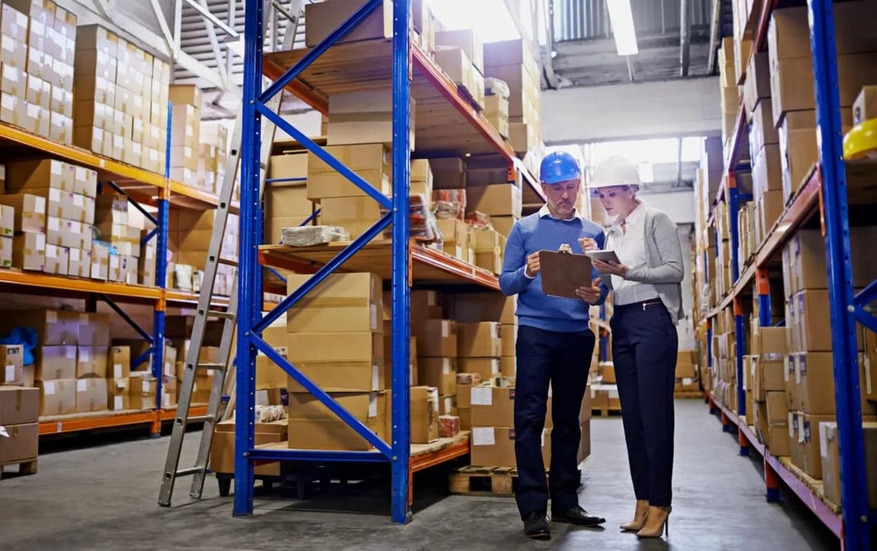 two people reviewing an clipboard in a warehouse