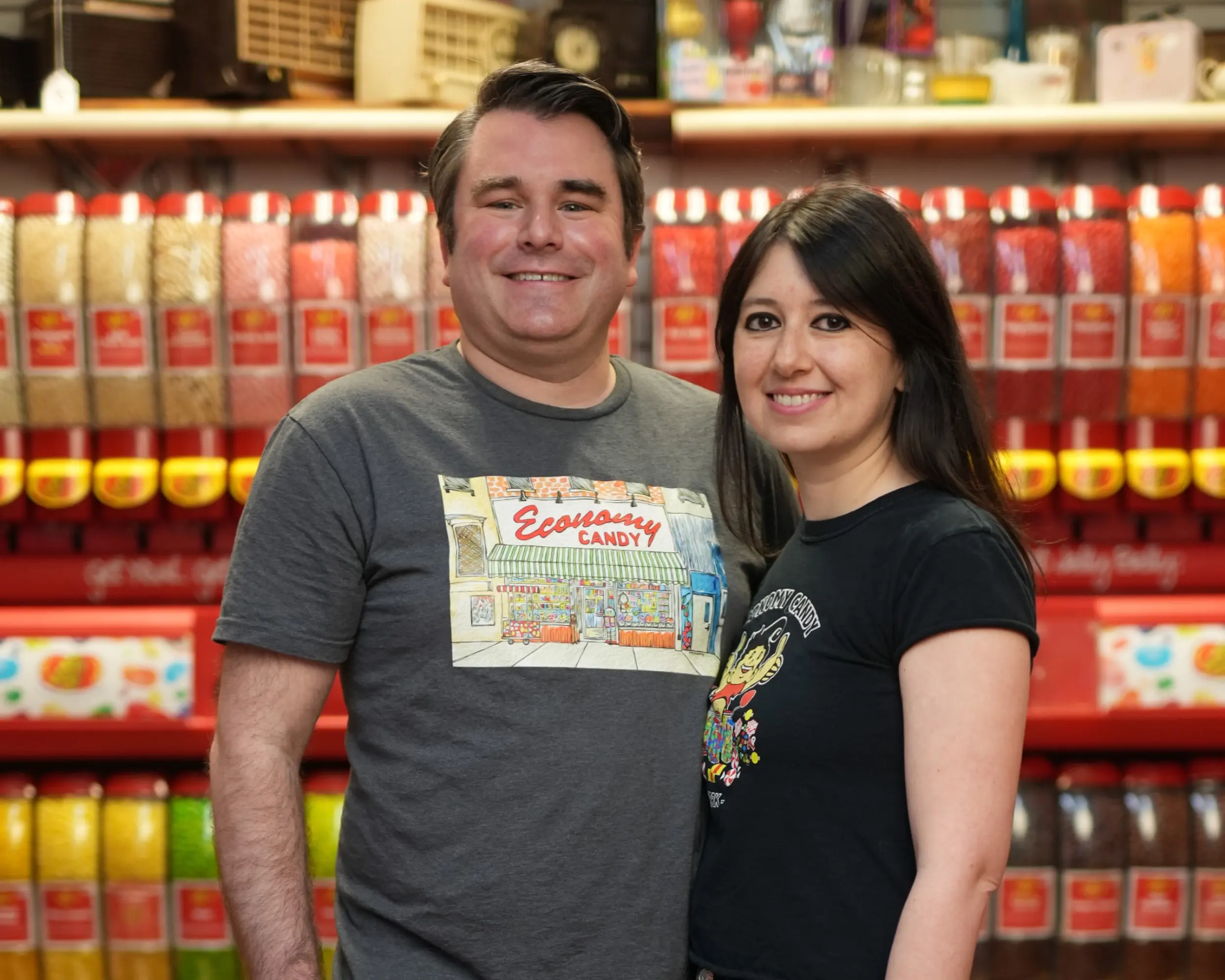 The owners of Economy Candy pose in their store wearing Economy Candy tshirts.