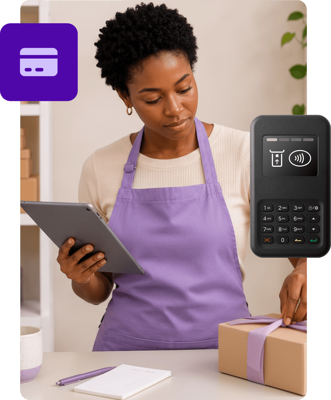 A person on a tablet in a shop boxing up an order, with a credit card icon and card reader overlays